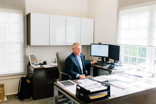Rob Grubb, Chief Operations Officer of OneAscent Wealth, sitting at his desk in the OneAscent Wealth office in Birmingham, AL