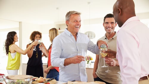 Group of men and women at a party mingling
