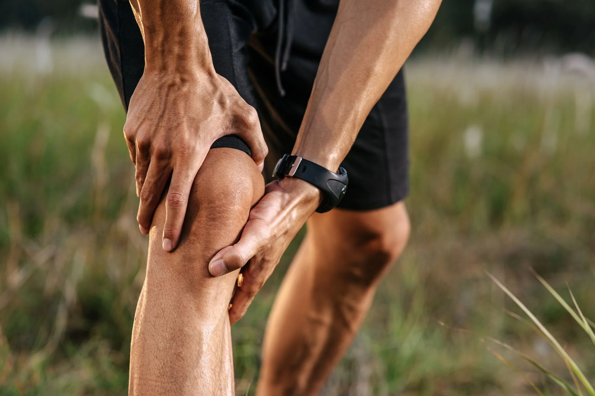 person holding knee in pain