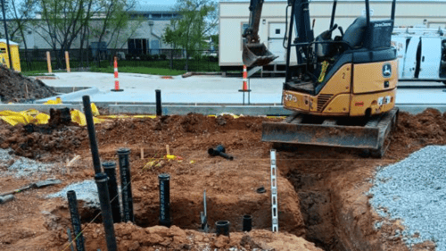 bucket loader at in-ground plumbing site