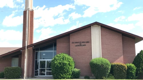 Light brown brick building with brown roof