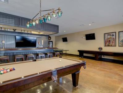Amenities room with brown modern pool table.