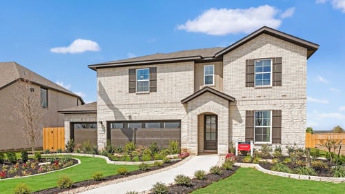 light brick exterior with dark brown window shutters and garage