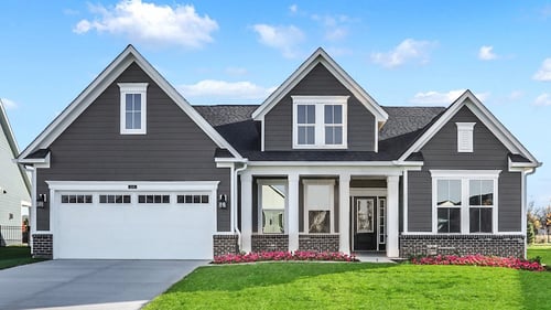 single-family home with gray exterior siding, garage, and yard
