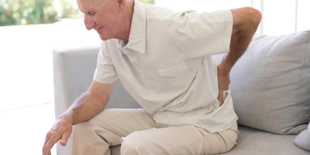 older man experiencing back pain