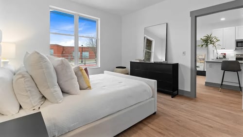 A bedroom with a large bed and a dresser with a mirror at The Ridge, Cincinnati, OH 45213