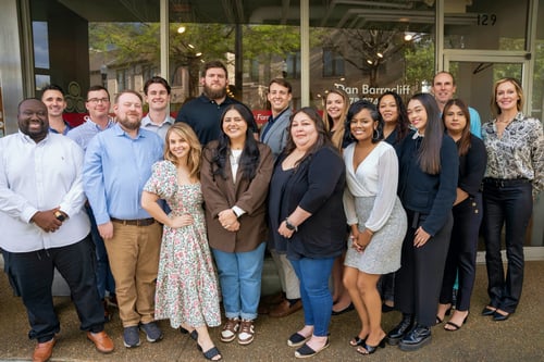 Dan Barracliff and his team pose together outside their State Farm Insurance building, showcasing a friendly and professional atmosphere.