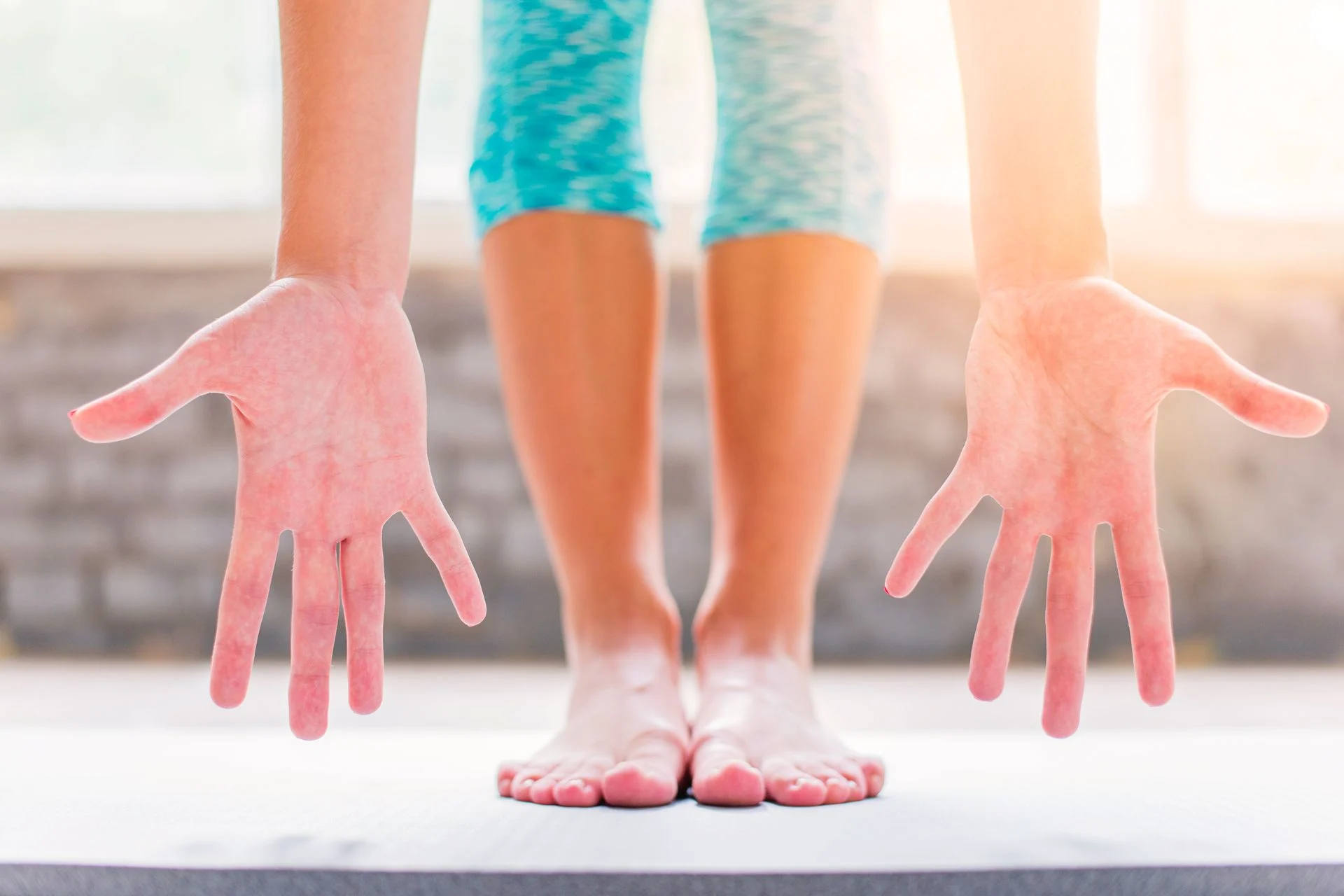Person with flat feet stretching with hands open