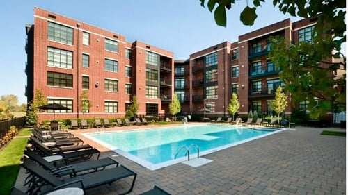 Property building and swimming pool at The Sheffield at Englewood South Apartments in Englewood, NJ