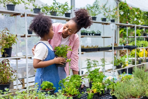 Mother gardening with her daughter.