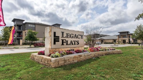 Property sign at Legacy Flats in San Antonio, TX 78254