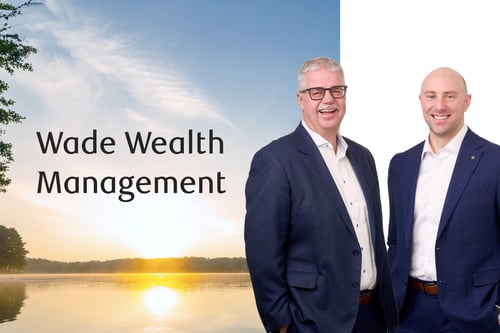 Frank Wade and Chris Cherepuschak standing in front of a lake at sunset.