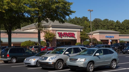 Cars parked in tree lined parking lot of T.J. Maxx