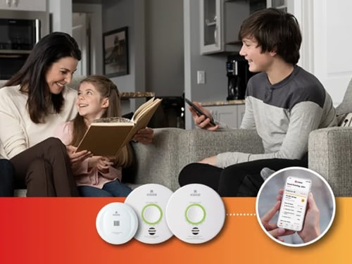 Family sitting in living room.