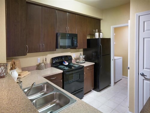 New Kitchens with Ceramic Tile Flooring, Custom Upgraded Cabinetry and Sleek Black Appliances at Courtney Bend Apartment Homes, Hardeeville, SC 29927