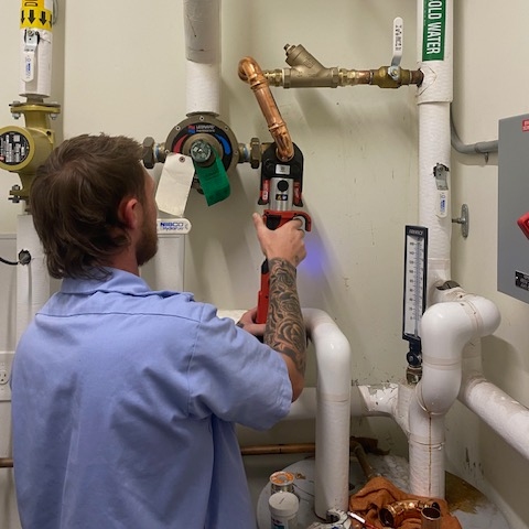 Bluefrog Plumbing + Drain technician evaluating residential plumbing and helping homeowners understand their repair options.