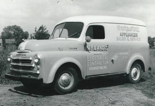 a black and white image of a vintage N. F. Landis work truck