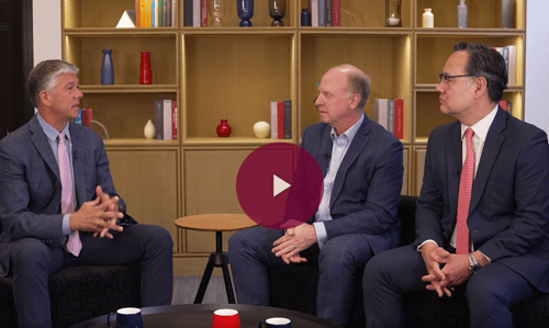 three men in conversation