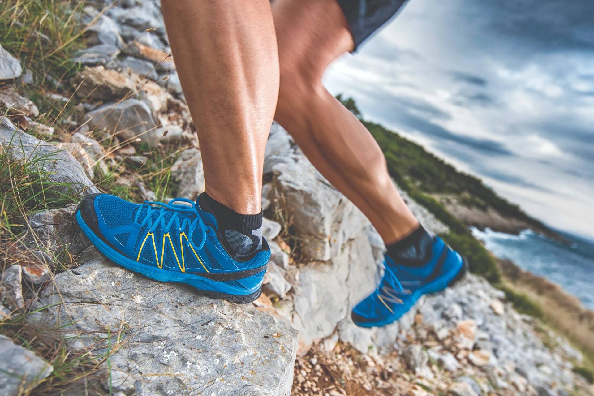 person with proper arch support while running in rocky terrain