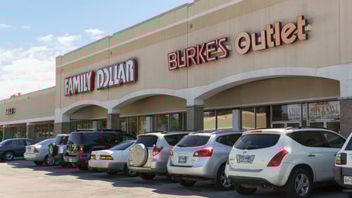 cars lined along the entrance of Family Dollar and Burke's Outlet