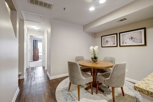 Dining area at Carriage Place Apartments with table setup and bright ambiance.