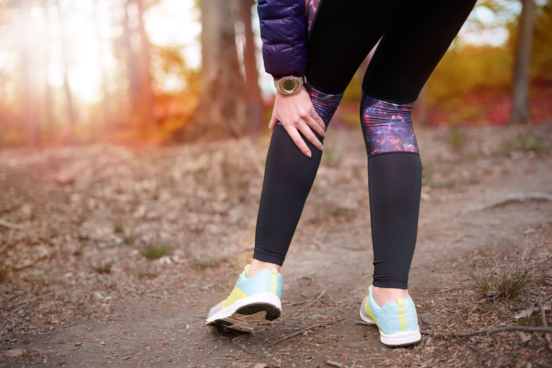 Person out in nature holding their knee