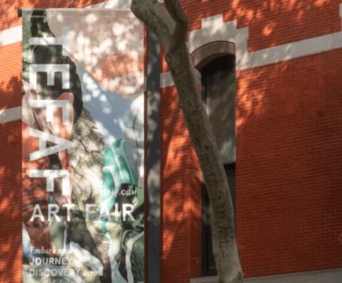 banner that reads "art fair" hanging outside a building