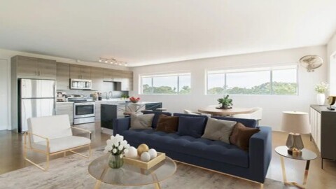 Modern open-concept apartment featuring a stylish kitchen with stainless steel appliances and a cozy living area.