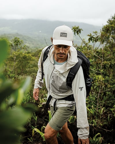 Man hiking in lush forest