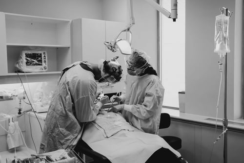 Oral surgeons working on a patient.