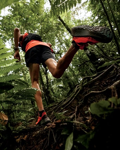 Man running through woods.