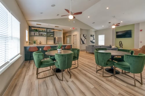 Clubhouse lounge with ample seating and a kitchen