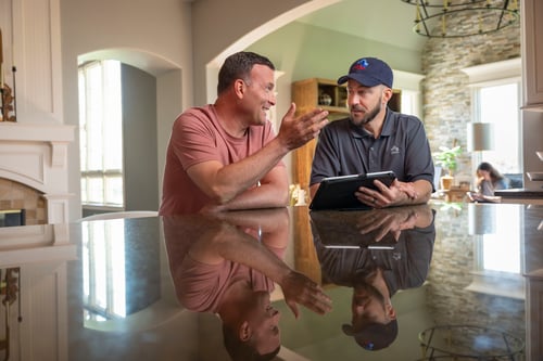 Customer and coordinator discussing inventory at dining room table