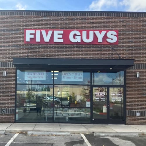 Exterior photograph of the entrance to the Five Guys restaurant at 4022 Pacific Avenue SE in Lacey Washington.