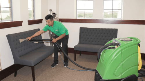 person cleaning a couch