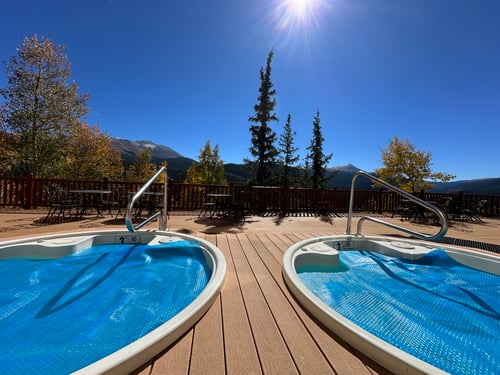 Two hot tubs ready for use on a bright sunny day.