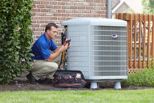A Carrier dealer performs air conditioner repair and service