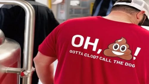 An employee at Bulldog Rooter with his shirt with the company slogan on it.