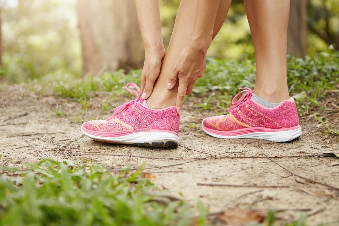 close up of woman's sneakers walking on a nature trail