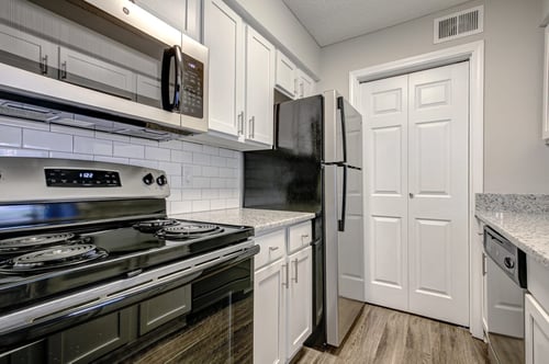 Upgraded Units Available with Sleek Black Appliances, Vinyl Plank Wood Flooring, Ceramic Tile Backsplash and Granite Like Countertops at The Edge of Germantown Apartments Home, Memphis, TN 38120