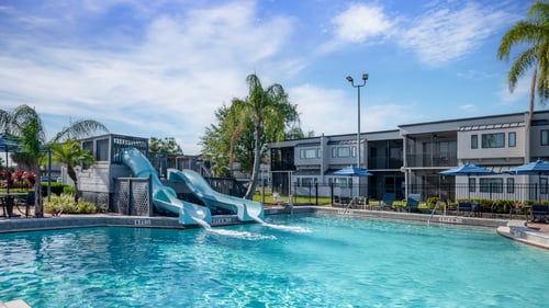 The outdoor pool with two slides at Orbit One Vacation Villas