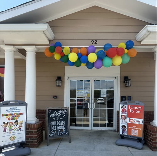 Front view of the school building with a welcoming entrance, designed to create a safe and friendly environment for children and families.