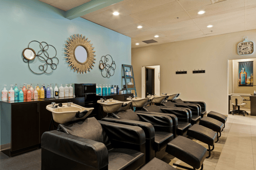 Five shampoo bowls with super comfy lounge chairs at Zoi'A Spa & Salon in Janesville, WI, offering an amazing scalp massage with every shampoo.