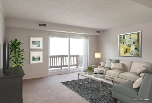 A living room with a grey couch, a coffee table, and a painting on the wall at Hummingbird Pointe & The Gardens, Ohio 44129