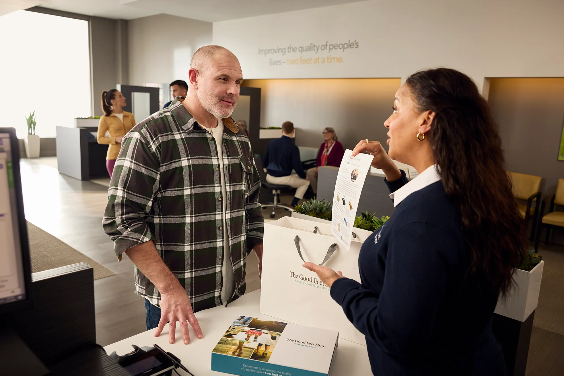 customer completing a purchase at The Good Feet Store