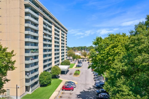 Exterior view of Glendale Park Apartments, a 13-story senior living community with balconies and parking in Memphis, TN.