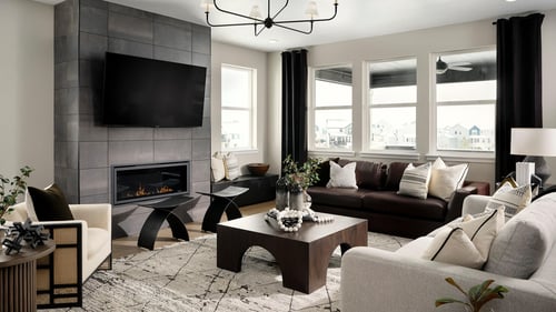 Expansive Gathering Room in the Parklane new construction home, showcasing high ceilings and a fireplace.