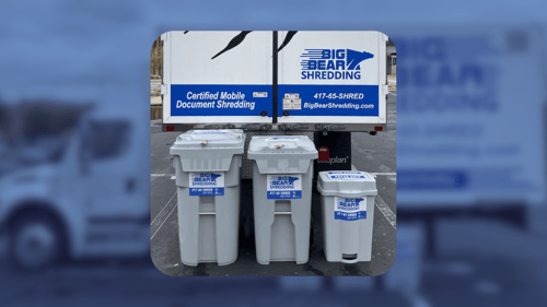 Big Bear Shredding truck in a parking lot with shredding collection bins in front of it