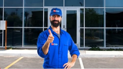 McCauley Glass worker standing in front of a commercial business