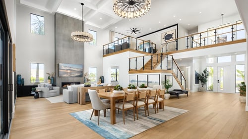 An open-concept great room bathed in natural light, featuring soaring two-story windows and effortless flow